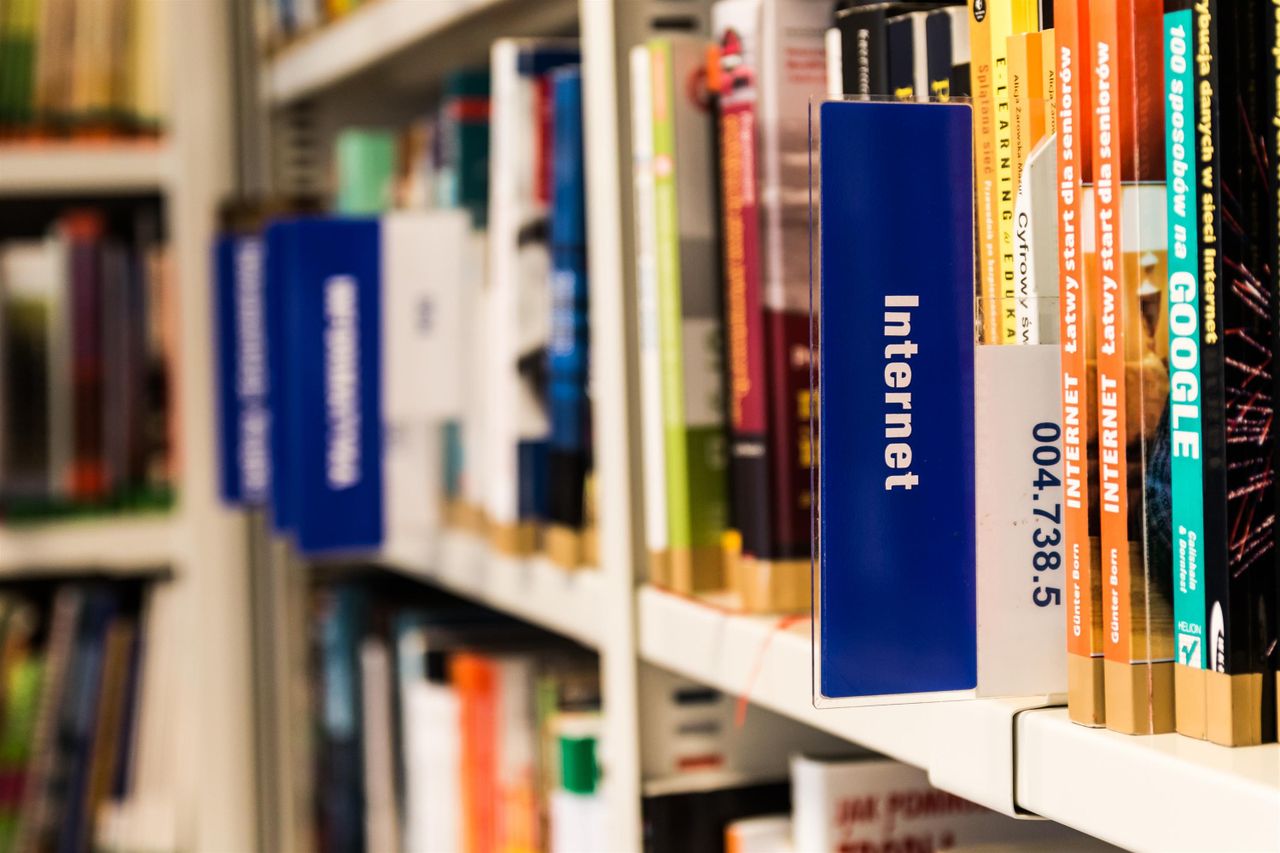 services-02 Close-up of a library shelf with books on internet and technology. Ideal for education-themed projects.